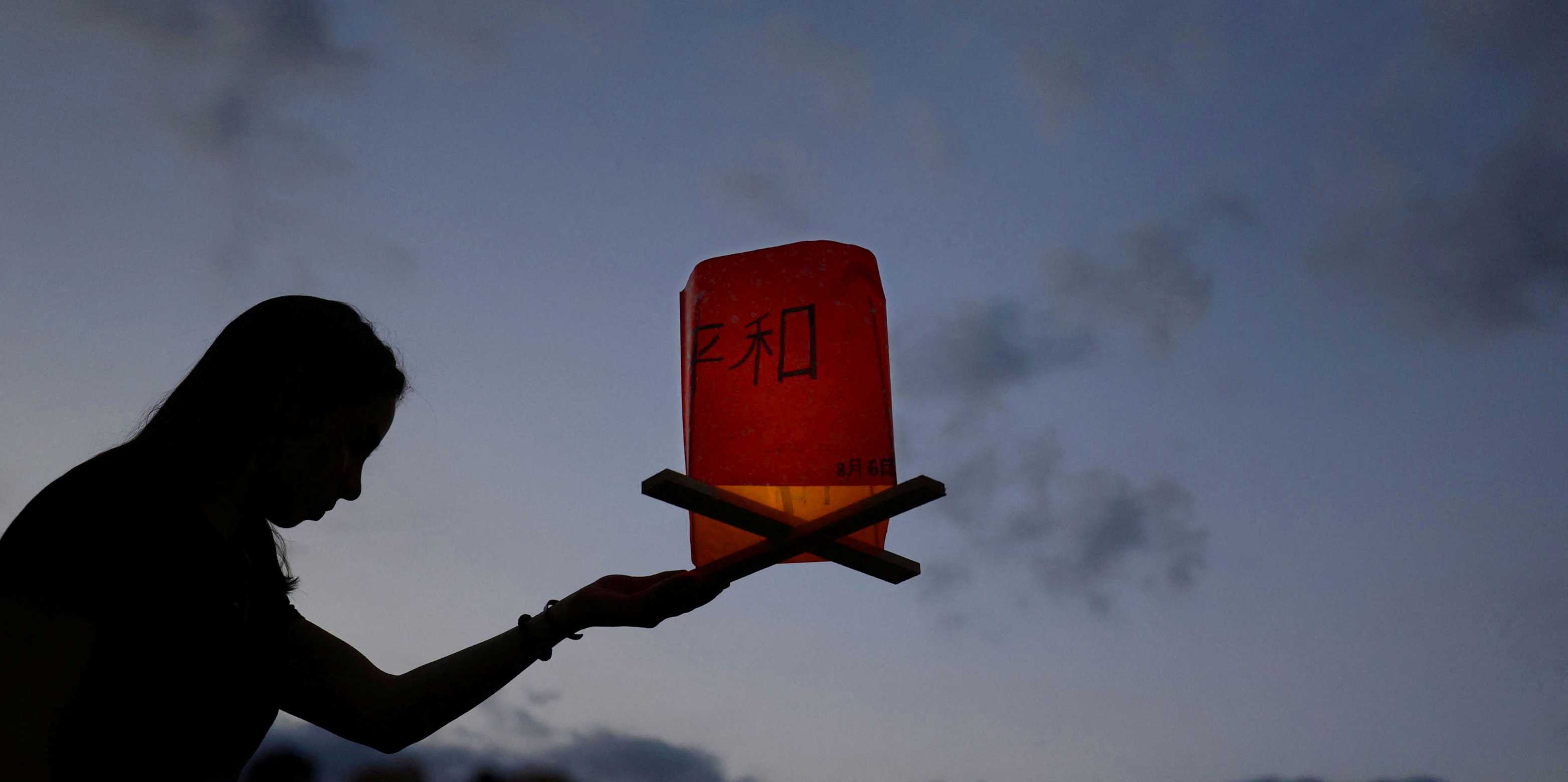 A woman holds a paper lantern in remembrance of atomic bomb victims on the anniversary of the atomic bombing in Hiroshima on 6 August 2023.